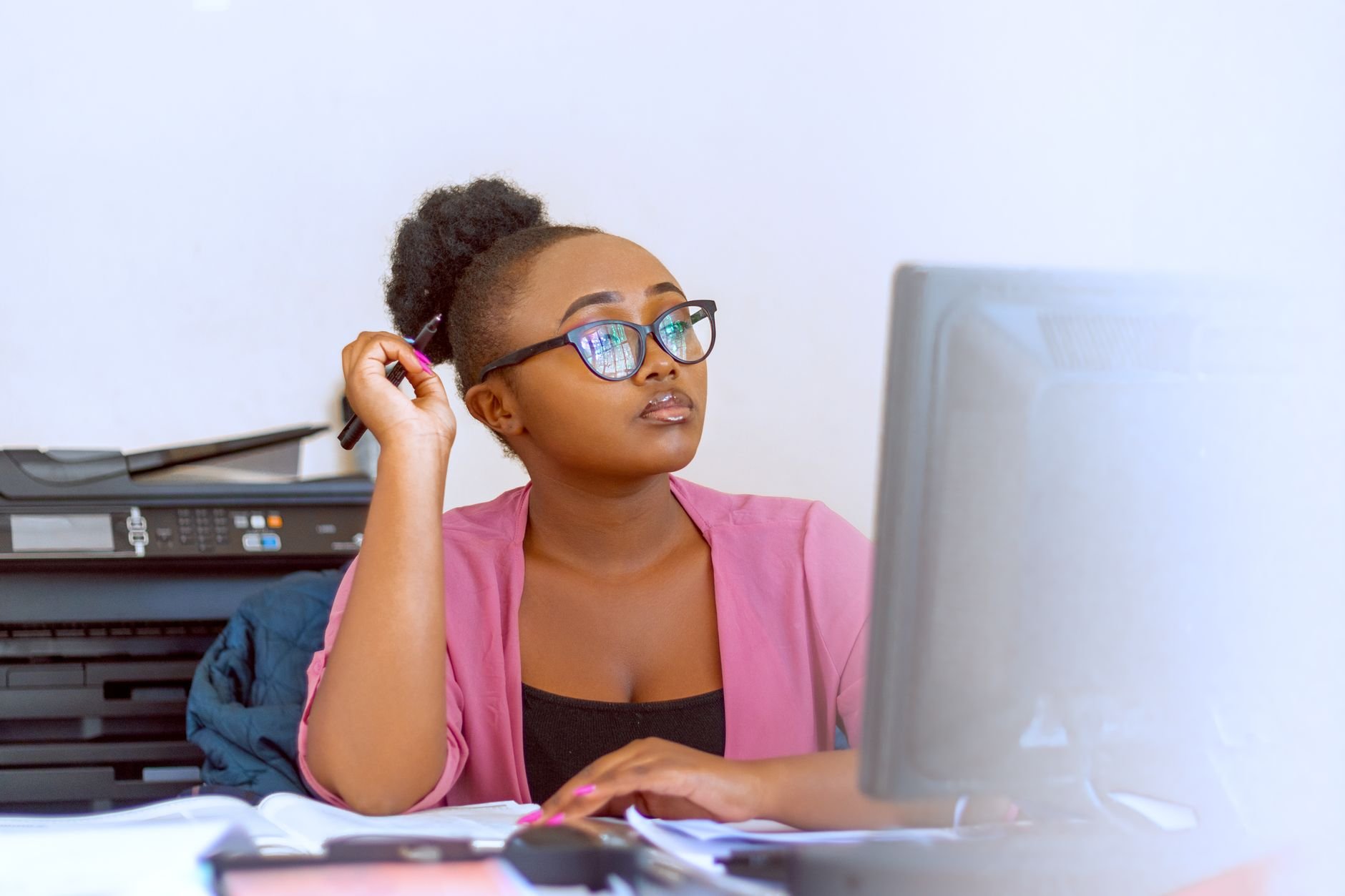 A focused healthcare administrator working efficiently at a computer desk
